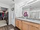 The well-lit bathroom offers a large mirror over double sinks and a view to the walk-in closet and shower at 1425 Hart Ln, Elizabeth, CO 80107