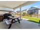 Covered patio area with a picnic table and grill, perfect for outdoor dining and entertaining with neighbors at 1425 Hart Ln, Elizabeth, CO 80107