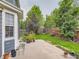 Home exterior with patio, fenced yard, and lush green landscaping at 9865 Centre Cir, Parker, CO 80134