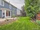 Backyard view with well-maintained lawn, patio, and privacy fence at 9865 Centre Cir, Parker, CO 80134
