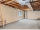 Unfinished basement with exposed beams, concrete walls, and small window at 9865 Centre Cir, Parker, CO 80134