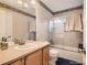 Bathroom showcasing vanity, toilet, and tiled shower-tub combo at 9865 Centre Cir, Parker, CO 80134