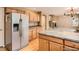 This kitchen features a breakfast bar, stainless appliances and easy access to living room at 9865 Centre Cir, Parker, CO 80134