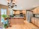 Bright kitchen boasts hardwood floors, a stylish chandelier, and stainless steel appliances at 9865 Centre Cir, Parker, CO 80134