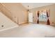 Inviting living room featuring a staircase, large windows, and neutral decor at 9865 Centre Cir, Parker, CO 80134