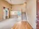 Open living room with hardwood floors leading to carpet, a staircase, and natural light at 9865 Centre Cir, Parker, CO 80134