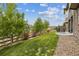 Serene backyard with a lush lawn, beautiful landscaping, a stone patio and a wooden fence at 16902 W 94Th Pl, Arvada, CO 80007