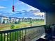 Balcony view overlooking houses, green space, and hummingbird feeders for an outdoor experience at 16902 W 94Th Pl, Arvada, CO 80007