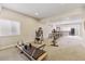 Finished basement rec room with gym equipment and wet bar at 16902 W 94Th Pl, Arvada, CO 80007