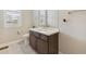 Bathroom features a modern sink and a toilet by the window allowing for natural light at 16902 W 94Th Pl, Arvada, CO 80007