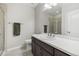 Bright bathroom featuring a sleek vanity, modern fixtures, a glass-enclosed shower, and a neutral color palette at 16902 W 94Th Pl, Arvada, CO 80007
