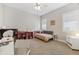 Bright bedroom featuring a daybed, ceiling fan and neutral walls for a calm atmosphere at 16902 W 94Th Pl, Arvada, CO 80007