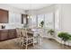 Bright dining area featuring wood floors, modern lighting, and windows with plantation shutters at 16902 W 94Th Pl, Arvada, CO 80007