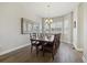 Dining room featuring a chandelier, large mirror, and a bay window with shutter-style window coverings at 16902 W 94Th Pl, Arvada, CO 80007