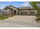 Charming home featuring stone accents and a spacious three-car garage, providing ample parking and curb appeal at 16902 W 94Th Pl, Arvada, CO 80007