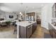 Open kitchen with island and stainless steel dishwasher adjacent to Gathering and dining rooms at 16902 W 94Th Pl, Arvada, CO 80007