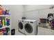 Laundry room with large capacity washer and dryer with sink and shelving at 16902 W 94Th Pl, Arvada, CO 80007