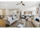 Spacious living area with hardwood floors flowing into the kitchen and dining areas at 16902 W 94Th Pl, Arvada, CO 80007
