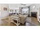 Open-concept living room with hardwood floors, a fireplace, and views into the kitchen area at 16902 W 94Th Pl, Arvada, CO 80007