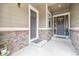 Inviting covered entryway with stone accents, showcasing a welcoming entrance to the home at 16902 W 94Th Pl, Arvada, CO 80007