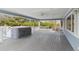 Relaxing back porch featuring a built-in hot tub and a ceiling fan for ultimate comfort at 2225 Linda Vista Dr, Lakewood, CO 80215