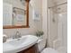 Bathroom with white sink, bright shower stall, and classic wood accents at 2225 Linda Vista Dr, Lakewood, CO 80215