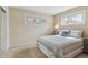 Relaxing bedroom with natural light streaming through two windows and two side tables with lamps at 2225 Linda Vista Dr, Lakewood, CO 80215