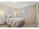 Cozy bedroom featuring a comfortable bed with stylish bedding and a bright window at 2225 Linda Vista Dr, Lakewood, CO 80215