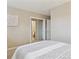 Bright bedroom featuring mirrored closet doors and an en suite bathroom entrance at 2225 Linda Vista Dr, Lakewood, CO 80215