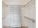 Walk-in closet featuring ample shelving and wooden rods for organization at 2225 Linda Vista Dr, Lakewood, CO 80215