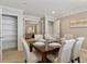 Dining area showcasing ample seating, decorative lighting, and dual entrances at 2225 Linda Vista Dr, Lakewood, CO 80215