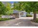 Charming light-blue home showcasing a welcoming porch and a well-maintained front yard with mature trees at 2225 Linda Vista Dr, Lakewood, CO 80215