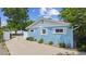 Side view of a charming blue house with white trim and a well-maintained concrete driveway at 2225 Linda Vista Dr, Lakewood, CO 80215