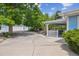 Light blue house featuring a covered patio, spa, garage and mature landscaping at 2225 Linda Vista Dr, Lakewood, CO 80215