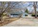 Charming blue home with a welcoming covered porch and manicured front yard, perfect for enjoying outdoor living at 2225 Linda Vista Dr, Lakewood, CO 80215