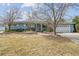 Inviting exterior with well-maintained landscaping, a walkway, and a two-car attached garage at 2225 Linda Vista Dr, Lakewood, CO 80215