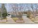 Charming home with a well-manicured front yard and a long driveway leading to a detached garage at 2225 Linda Vista Dr, Lakewood, CO 80215