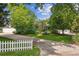 A well-manicured front yard with green grass and mature trees surrounding the house at 2225 Linda Vista Dr, Lakewood, CO 80215