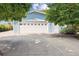 Exterior garage features a large driveway, blue siding, and a prominent white door with decorative windows at 2225 Linda Vista Dr, Lakewood, CO 80215