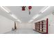 Spacious garage features bright lighting, shelving for storage, and painted flooring at 2225 Linda Vista Dr, Lakewood, CO 80215