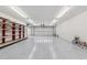 Bright garage features clean white floors, ample lighting, and a red storage rack at 2225 Linda Vista Dr, Lakewood, CO 80215