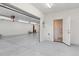 A bright, spacious garage with a door to a small adjacent bathroom at 2225 Linda Vista Dr, Lakewood, CO 80215
