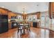 Classic kitchen featuring wooden cabinetry, wood flooring, and a cozy breakfast nook at 2225 Linda Vista Dr, Lakewood, CO 80215