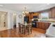 Eat-in kitchen with hardwood floors, stainless appliances, and adjacent pantry at 2225 Linda Vista Dr, Lakewood, CO 80215