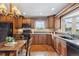 Traditional kitchen with wood cabinets, granite countertops, and stainless steel appliances at 2225 Linda Vista Dr, Lakewood, CO 80215