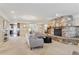 Bright living room with a unique stone fireplace, neutral decor, and open access to the dining area at 2225 Linda Vista Dr, Lakewood, CO 80215