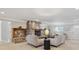 Cozy living room featuring a stone fireplace, comfortable seating, and ample natural light at 2225 Linda Vista Dr, Lakewood, CO 80215