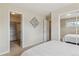 Main bedroom featuring walk-in closet, neutral walls, and closet with sliding doors at 2225 Linda Vista Dr, Lakewood, CO 80215