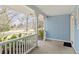 Welcoming covered porch with classic railing offering an inviting view of the front yard and neighborhood at 2225 Linda Vista Dr, Lakewood, CO 80215