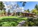 Expansive backyard showcases the home with a well-maintained lawn, and landscaping, offering a serene outdoor space at 6975 S Chase Ct, Littleton, CO 80128